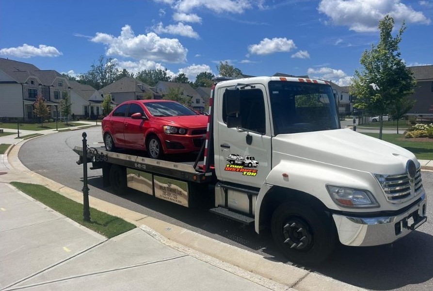 Long distance car towing Atlanta sunny day flatbed
